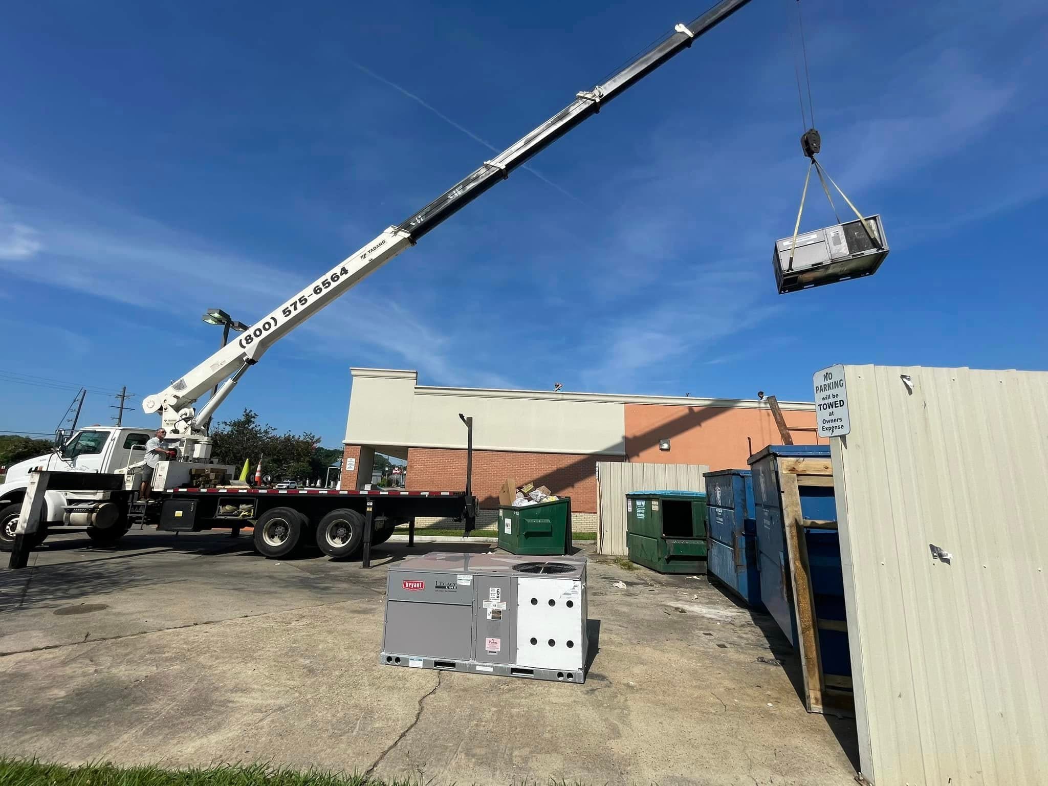 Commercial rooftop HVAC equipment placement with crane