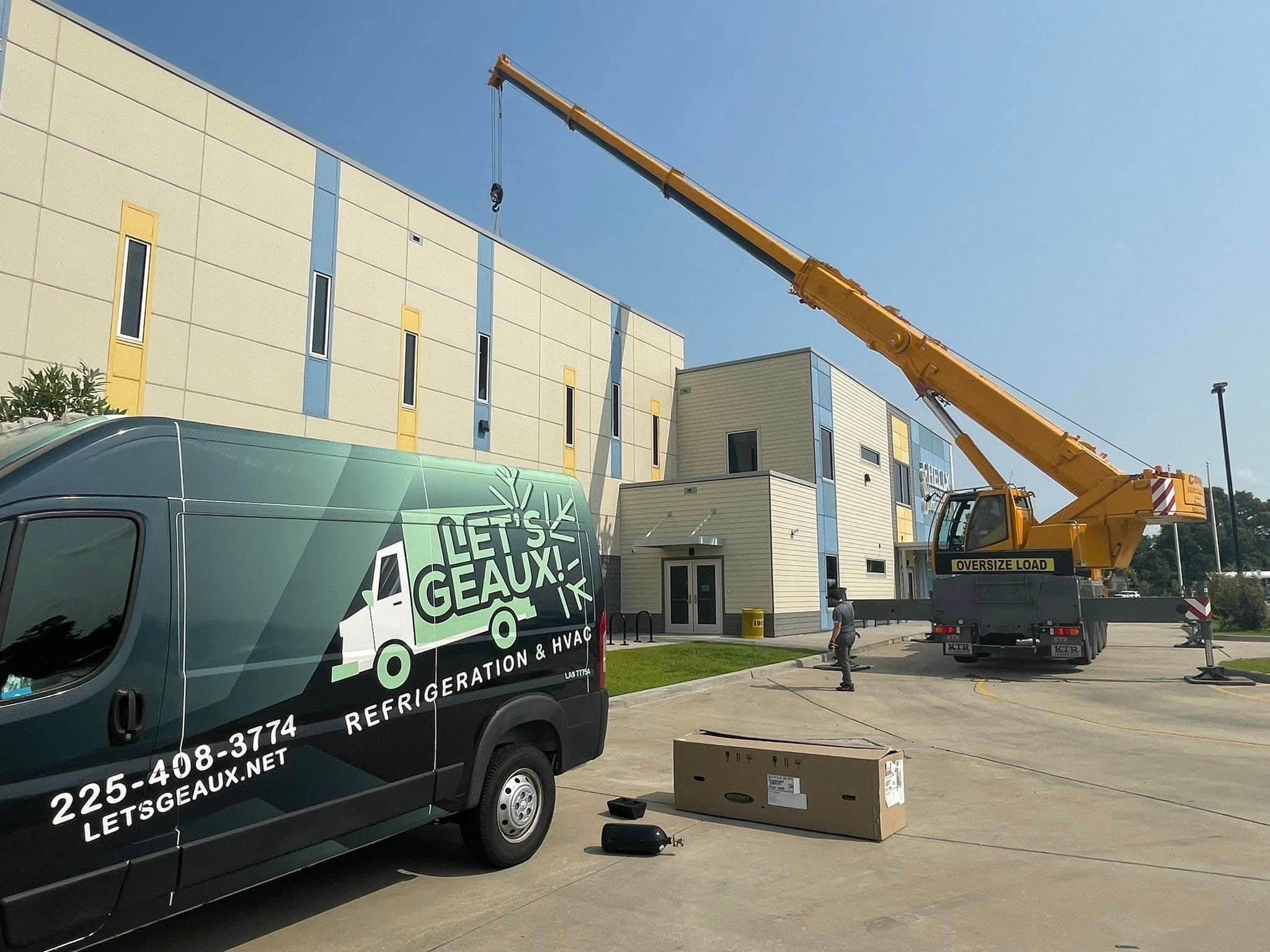 Let's Geaux commercial HVAC job site with service van and crane, Baton Rouge area